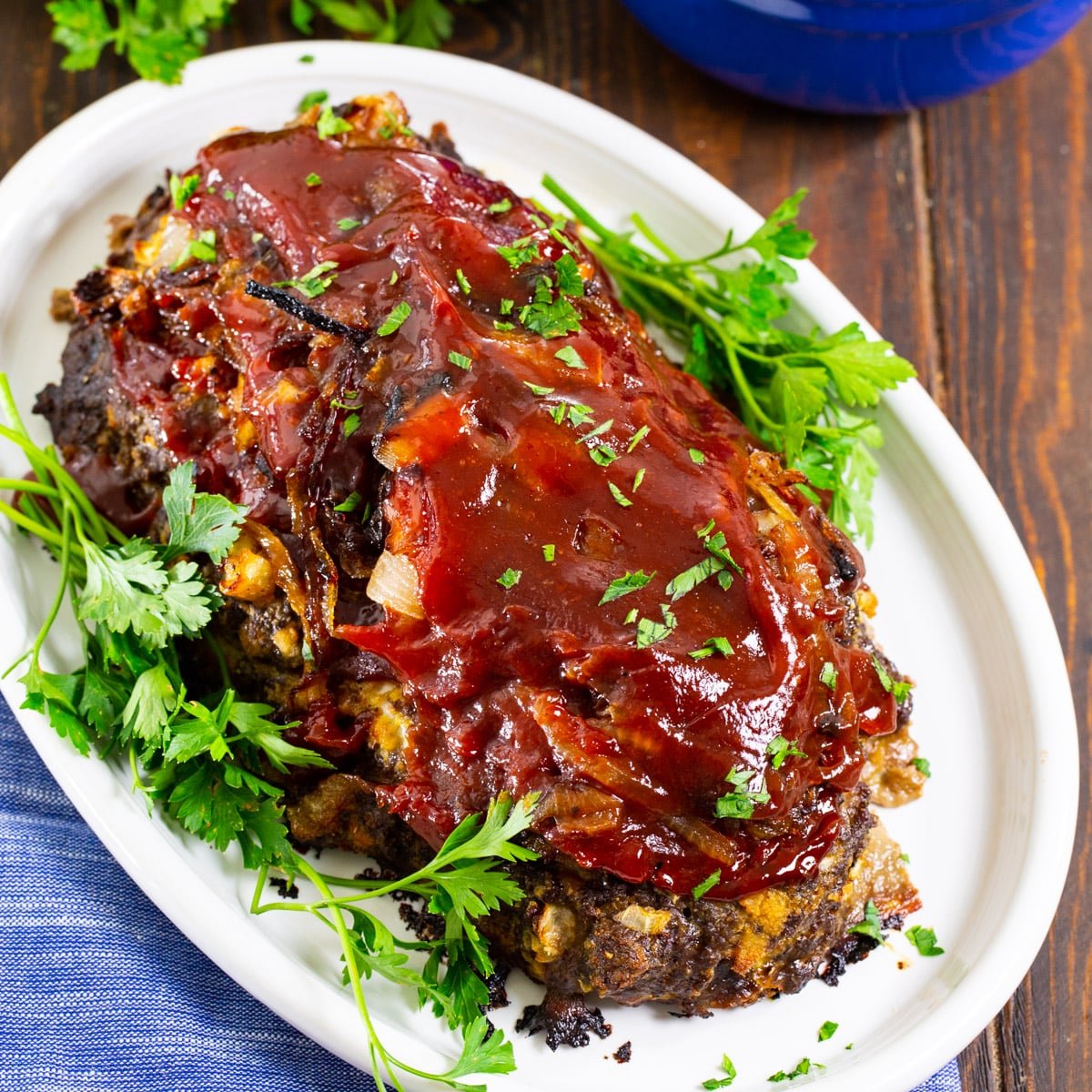 Caramelized Onion Meatloaf on serving platter with parsley.