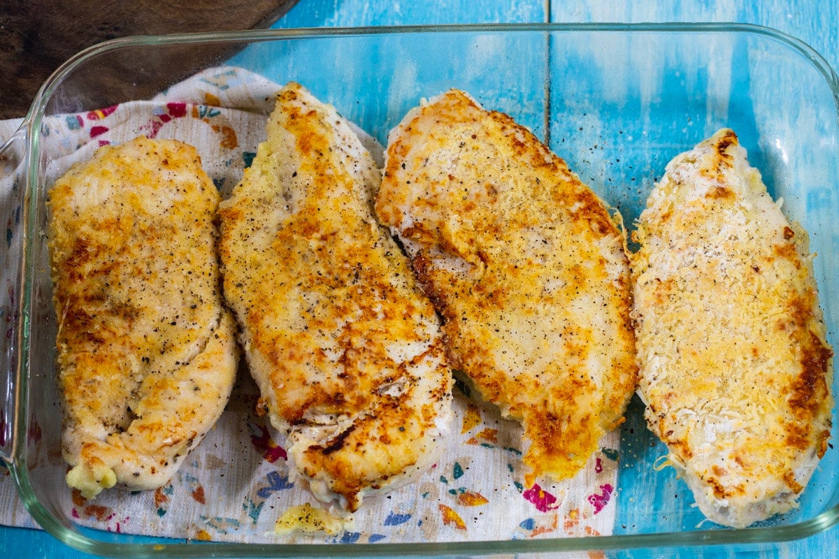 Sauteed chicken breasts in a baking dish.