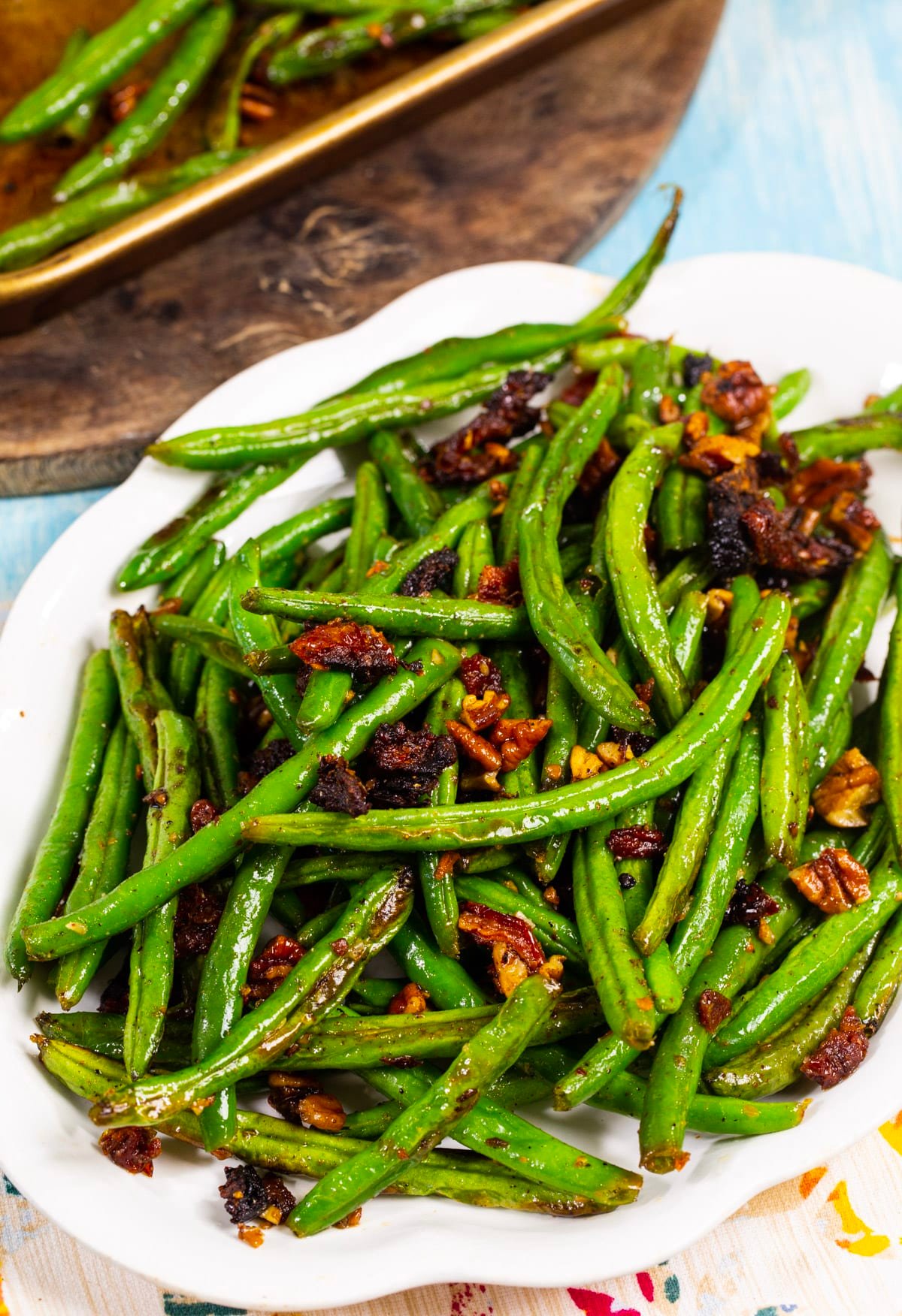 Green Beans roasted with sun-dried tomatoes on a serving plate.