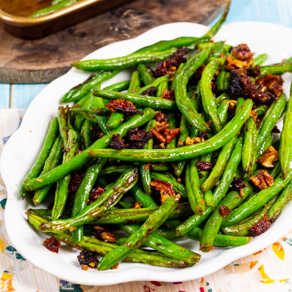 Roasted Green Beans with Sun-Dried Tomatoes on a serving plate.