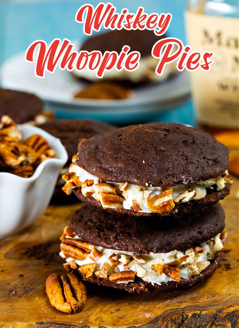 Whiskey Whoopie Pies stacked on a cutting board.
