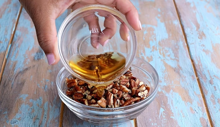 Adding bourbon to pecans.