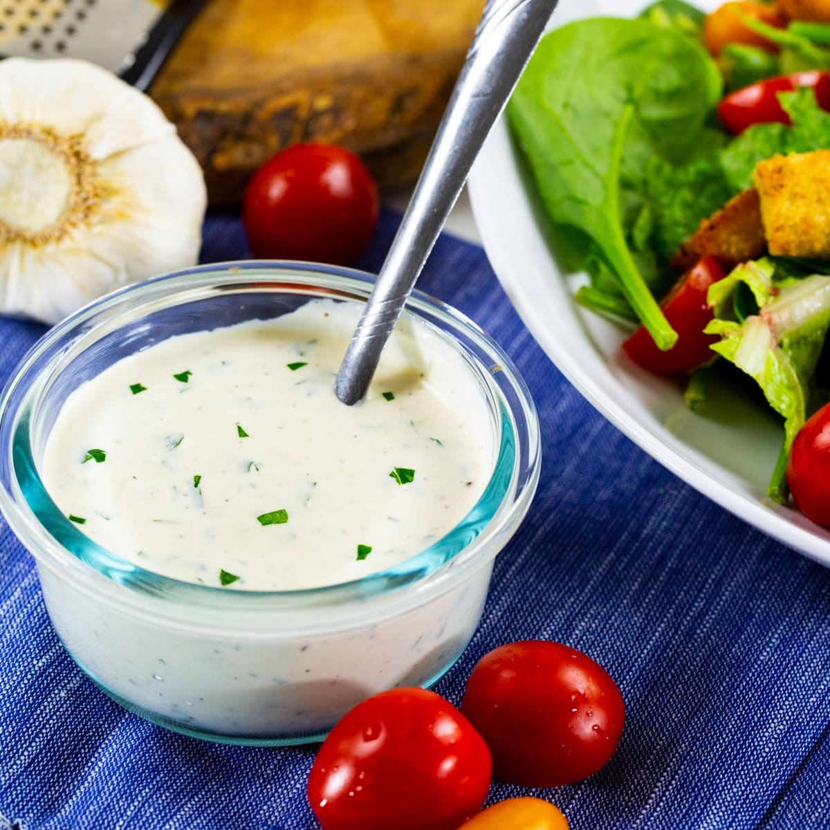 Creamy Parmesan Dressing in a bowl and salad next to it.