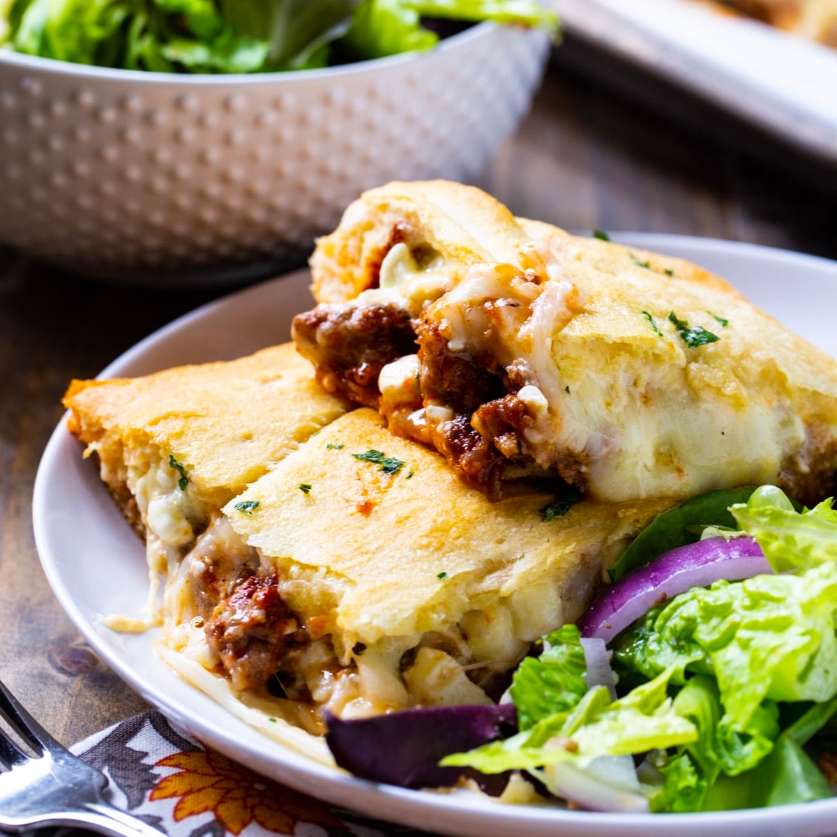Crescent Lasagna on a plate with salad.
