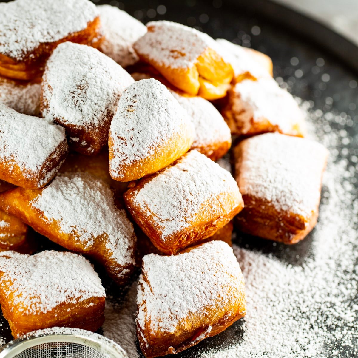 Homemade Beignets covered in powdered sugar.