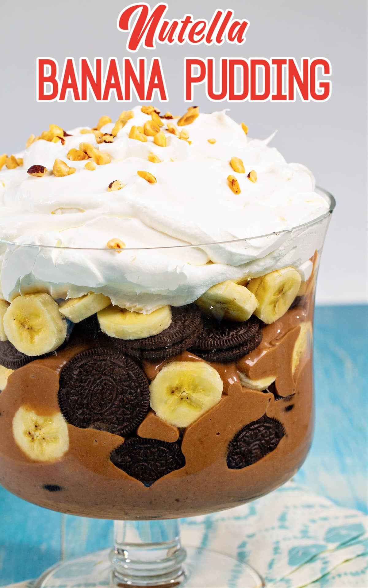 Nutella Banana Pudding topped with whipped cream and hazelnuts.