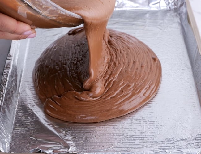 Pouring batter into pan.