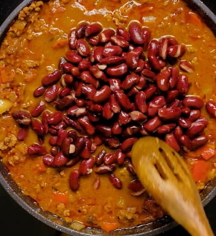 Stirring in beans.
