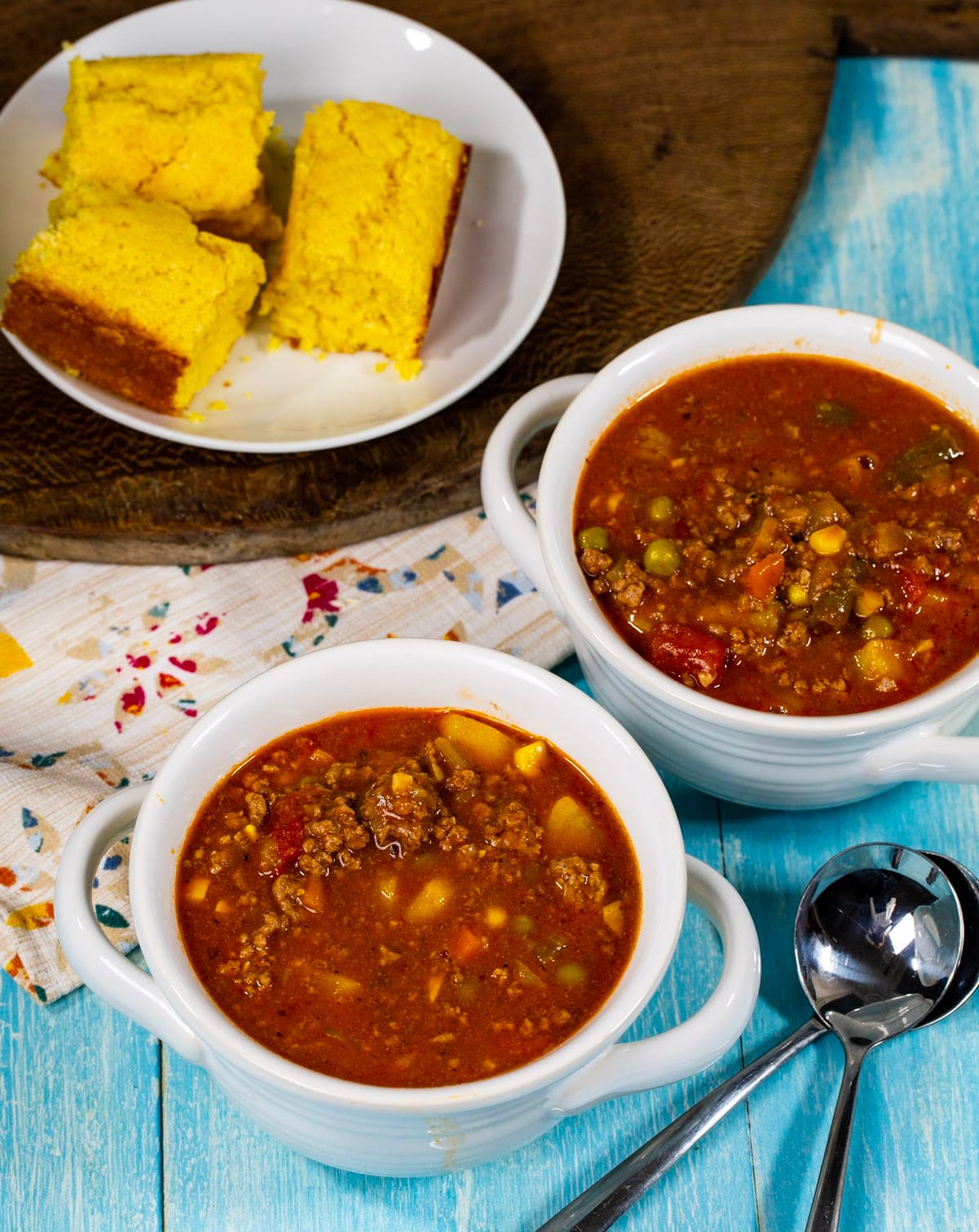 Stew in two bowls and plate or cornbread.