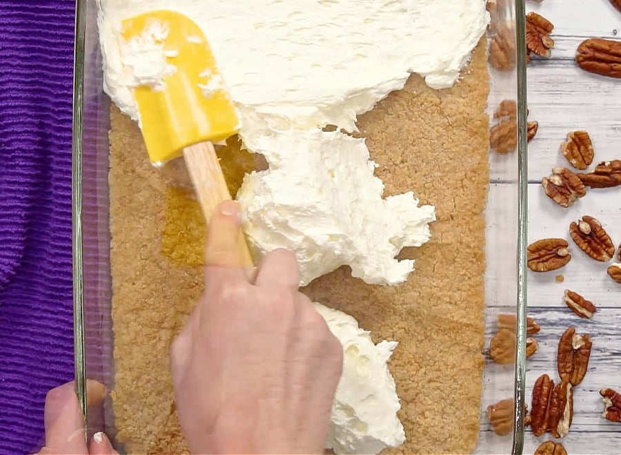 Spreading cream layer over crust.