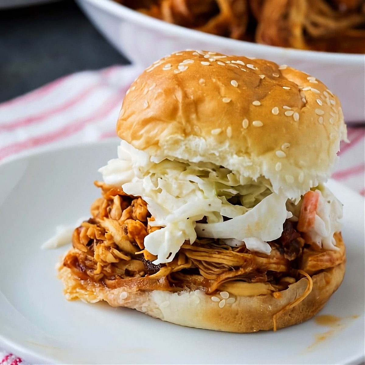 Chipotle Pulled Chicken with coleslaw on a bun.