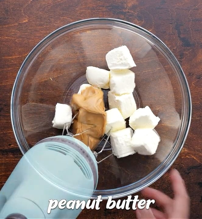 Beating peanut butter and cream cheese until smooth.