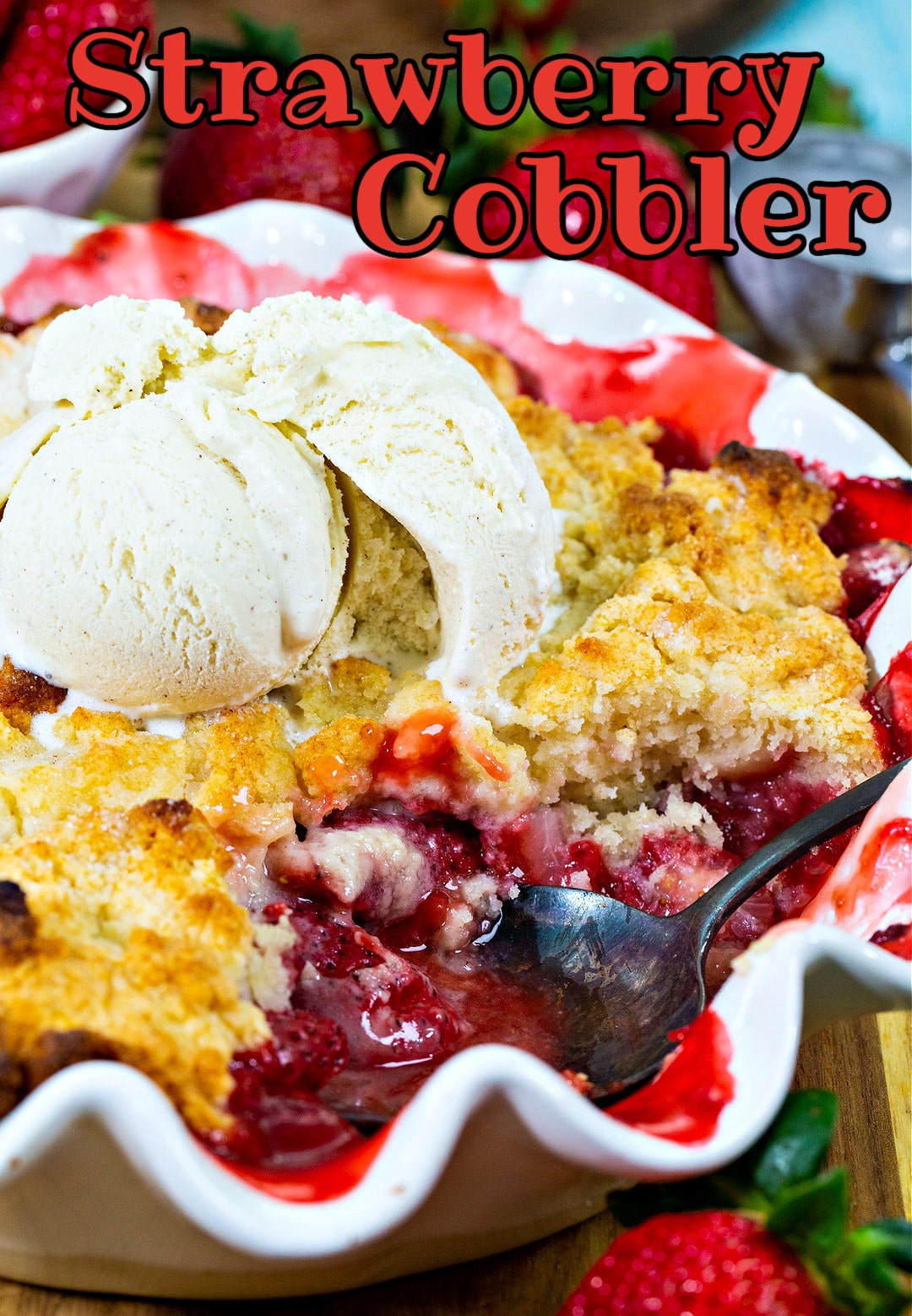 Cobbler with strawberries topped with ice cream.