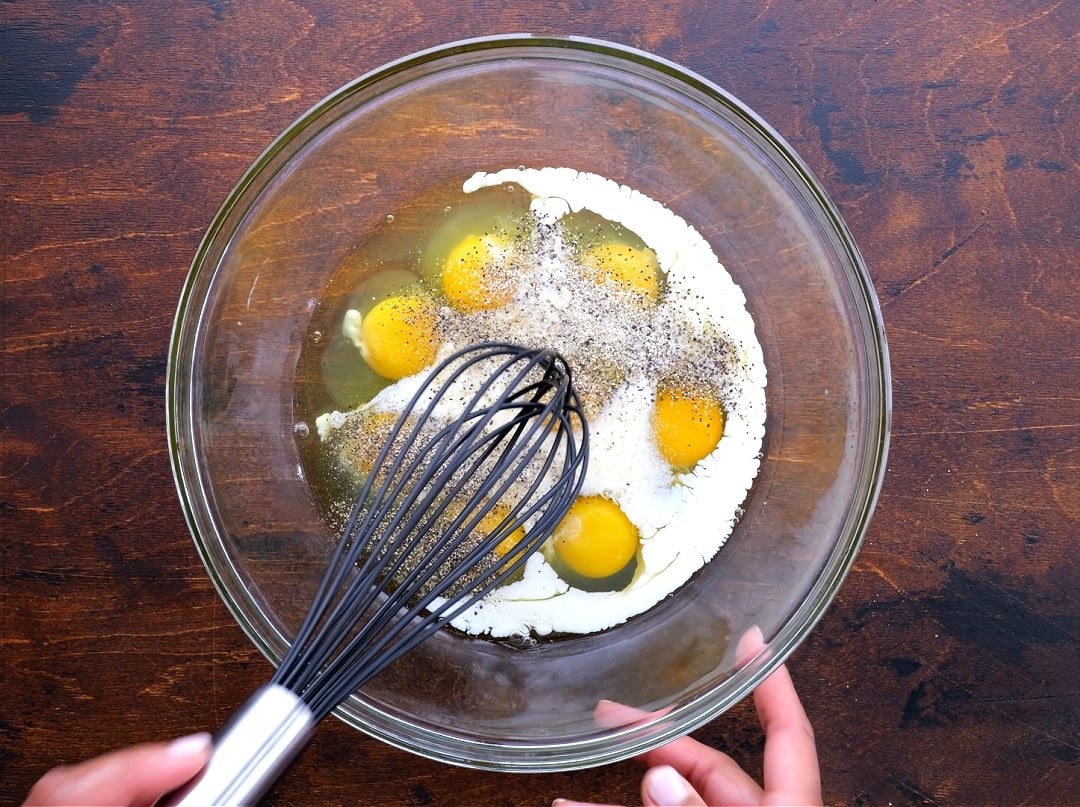 Whisking eggs and half-and-half.