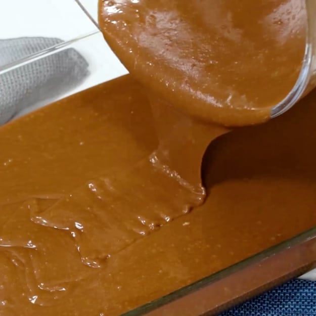 Pouring batter into pan.