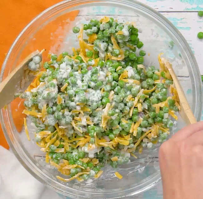 Mixing the pea salad.