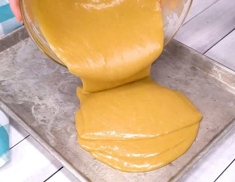 Pouring batter into pan.