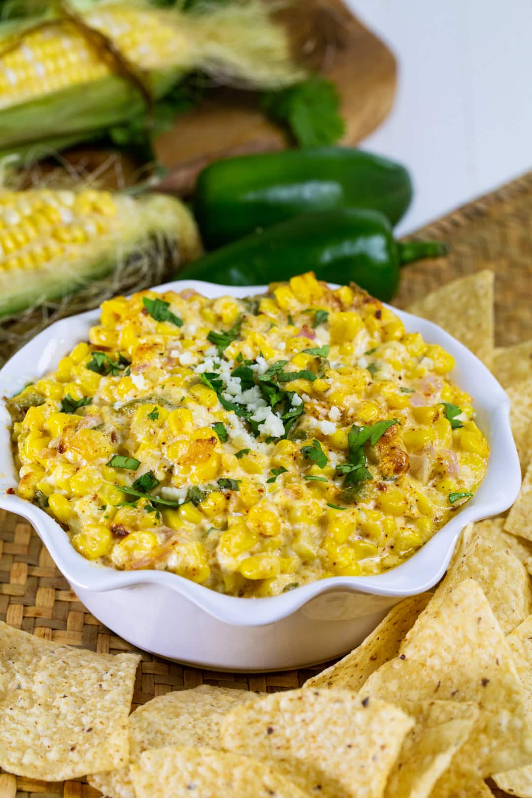 Corn Dip in a bowl surrounded by tortilla chips.
