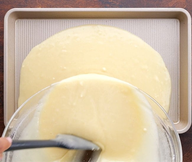 Pouring batter into pan.