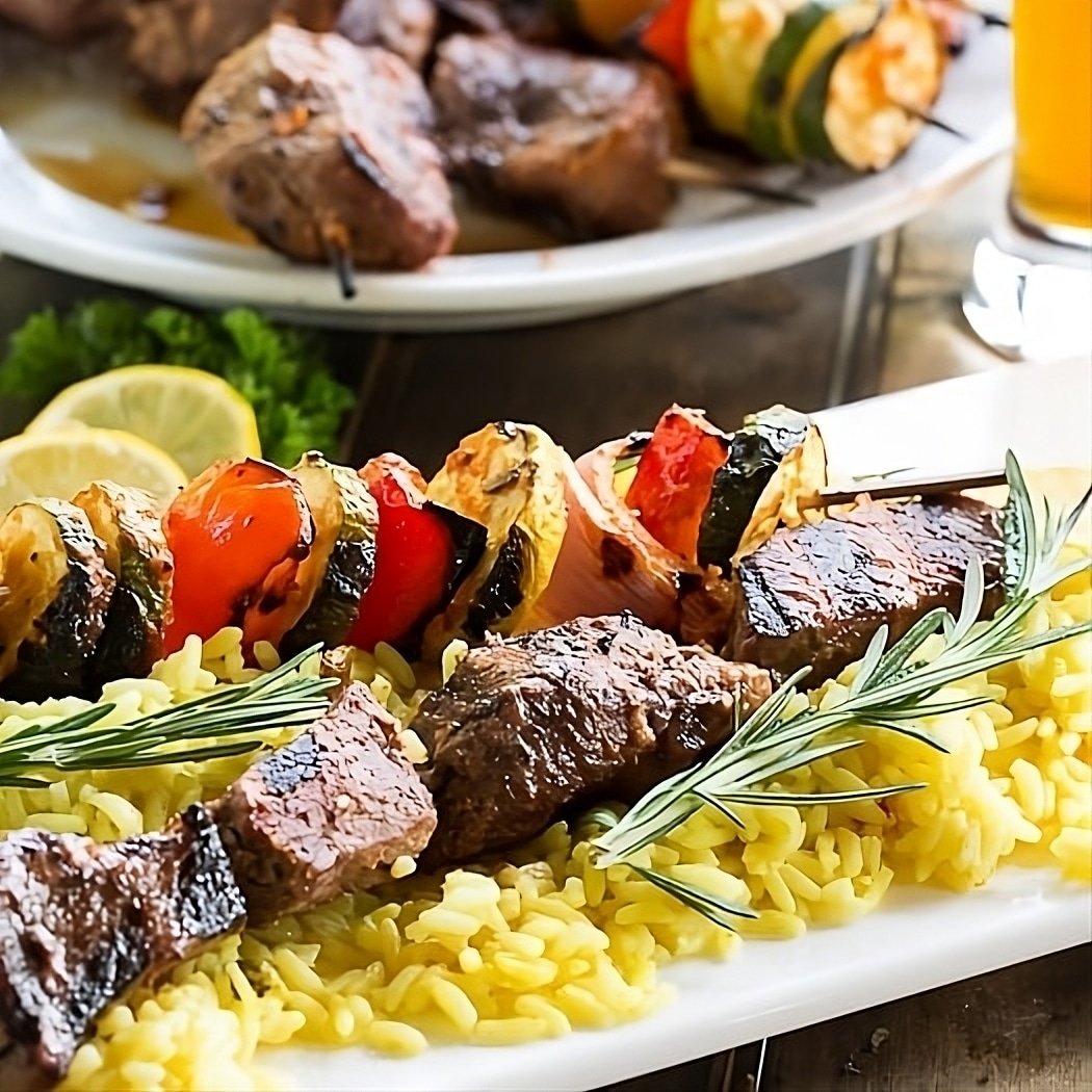 Grilled Beef Kabobs over yellow rice.