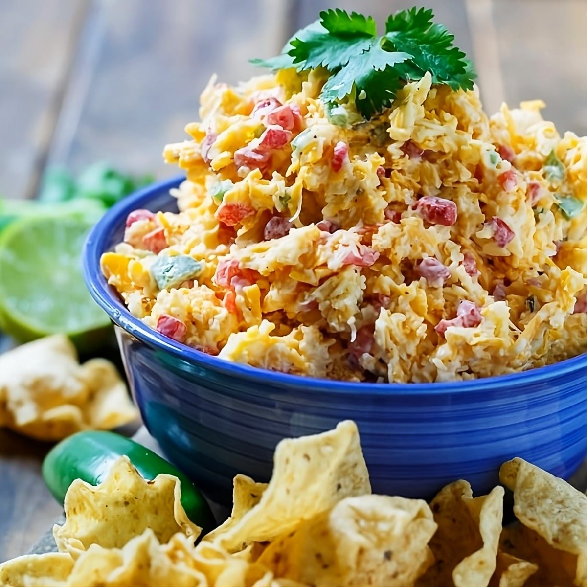 Tex-Mex Pimento Cheese in a bowl surrounded by tortilla chips.