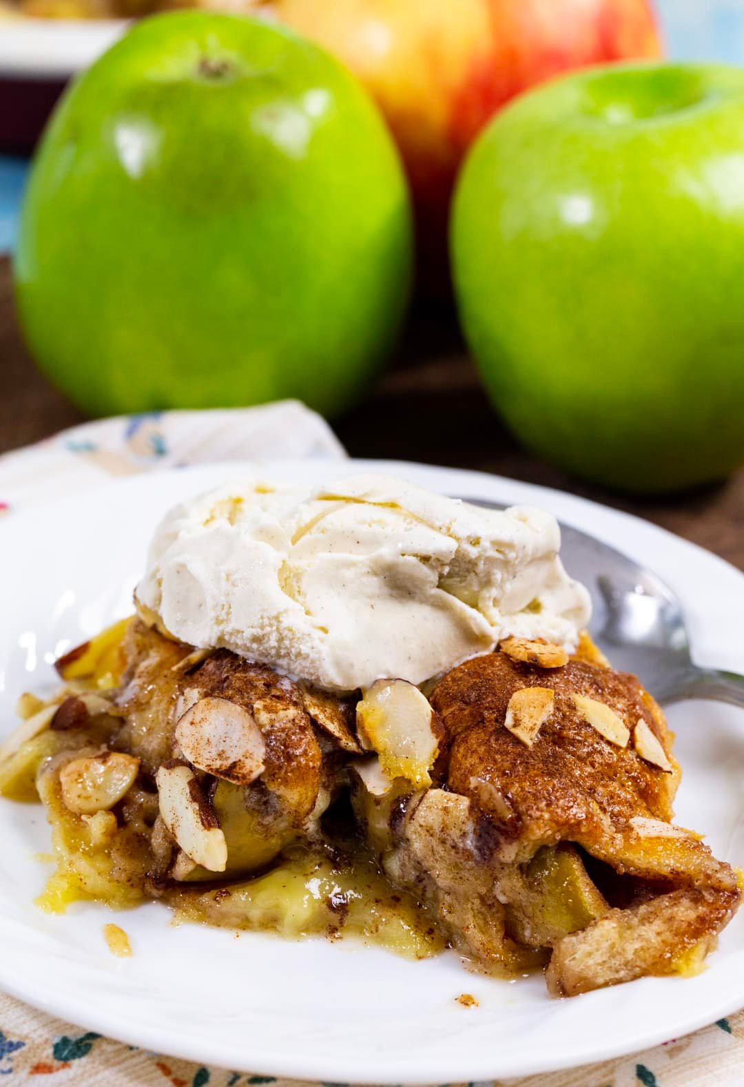 Crescent Apple casserole slice topped with vanilla ice cream.