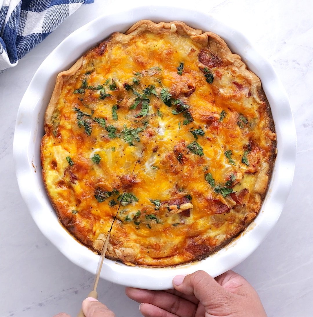 Cutting quiche into slices.