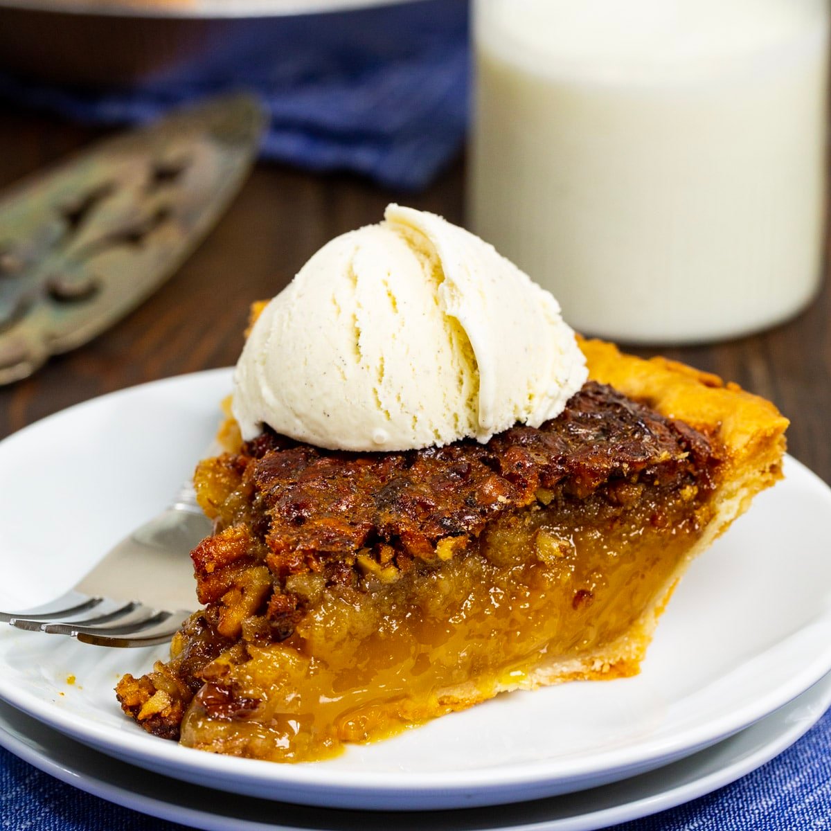 Slice of pie topped with vanilla ice cream.