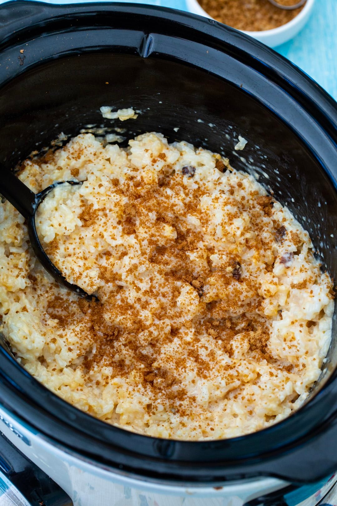 Slow Cooker Rice Pudding sprinkled with cinnamon.