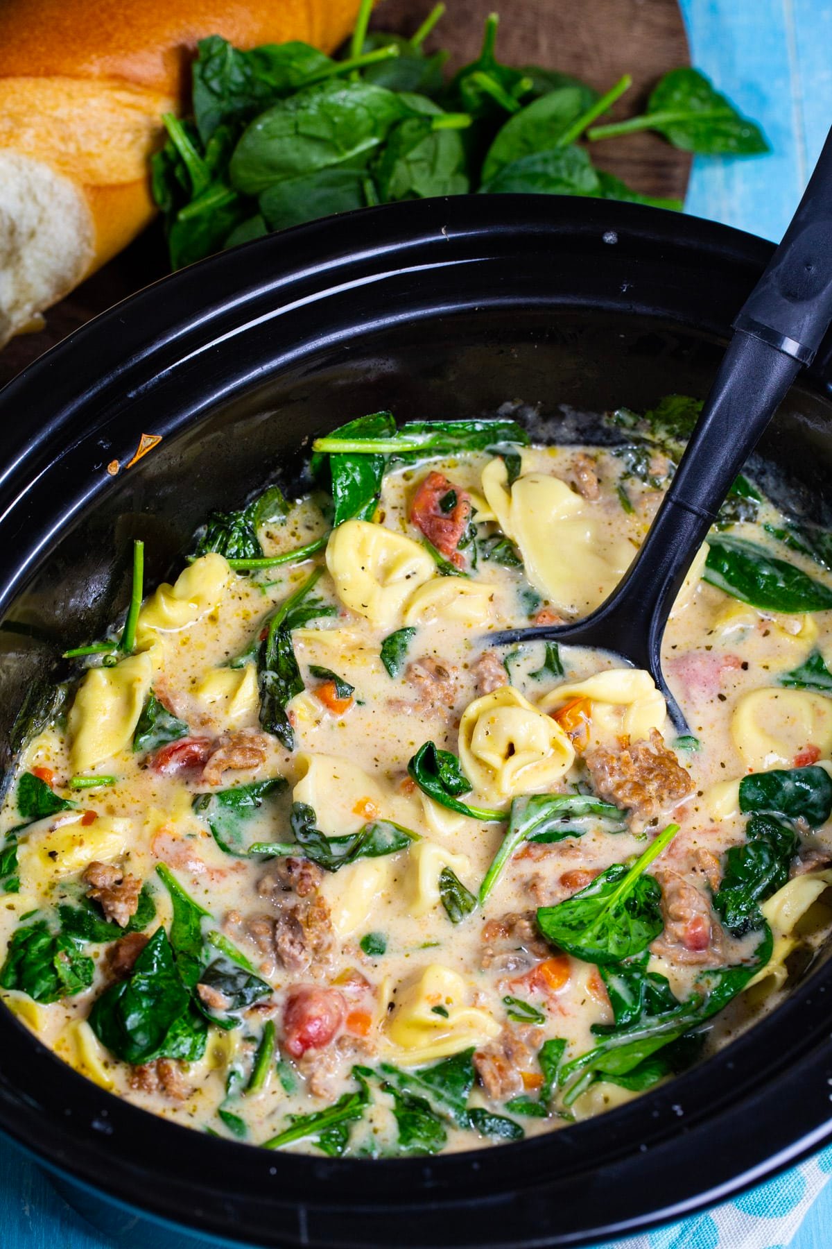 Ladle scooping soup out of slow cooker.