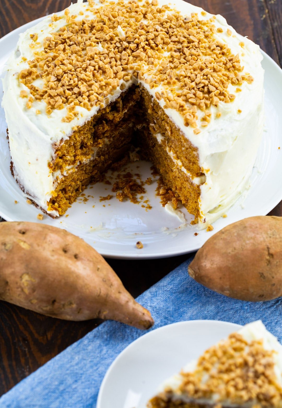 Cake on cake stand with slice cut out.