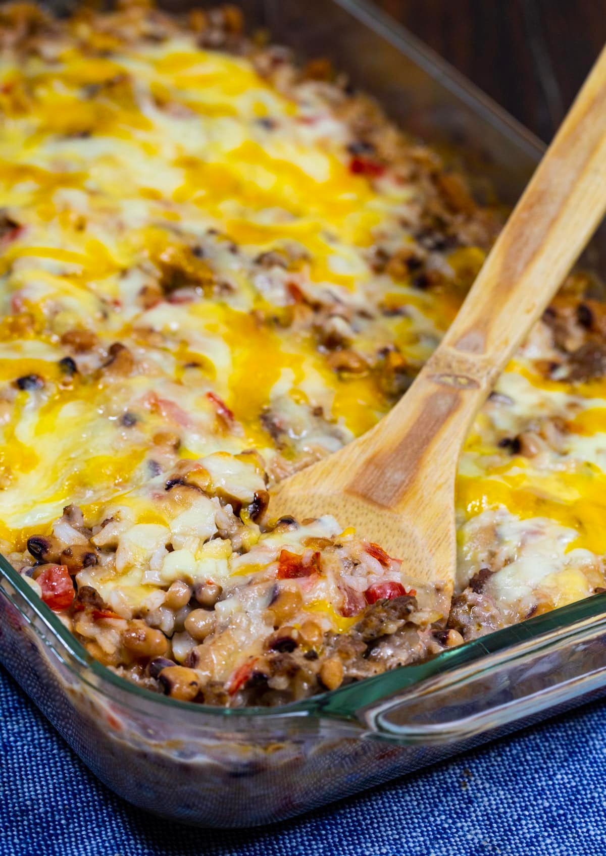 Wooden spoon scooping up casserole.