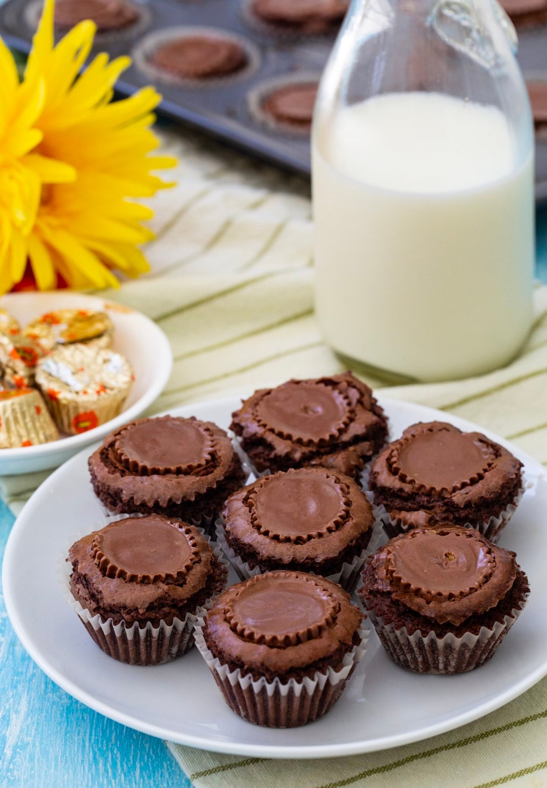 Brownie Buttons on a plate and a jar full of milk.