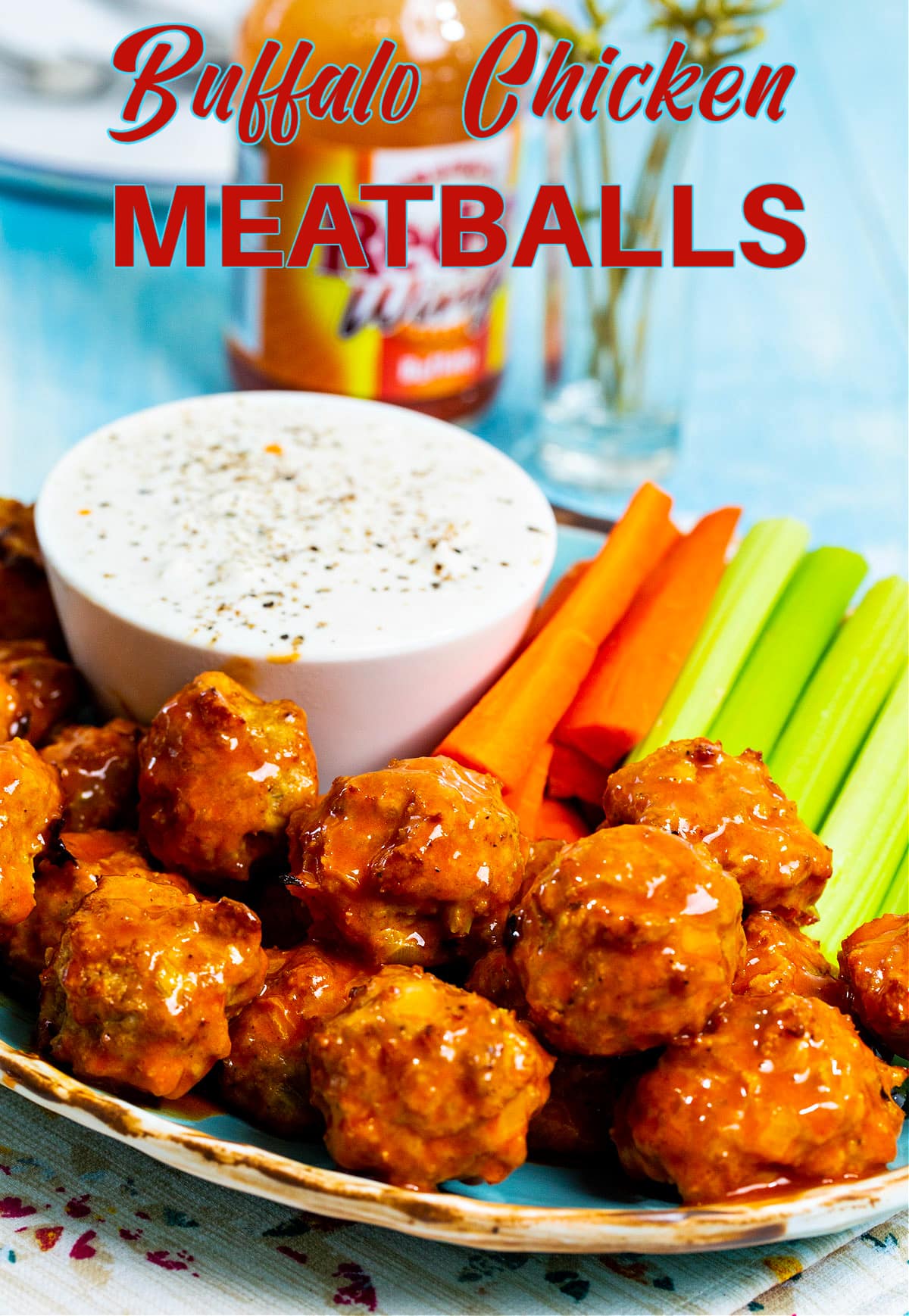 Buffalo Chicken Meatballs on plate with bowl of ranch dipping sauce.