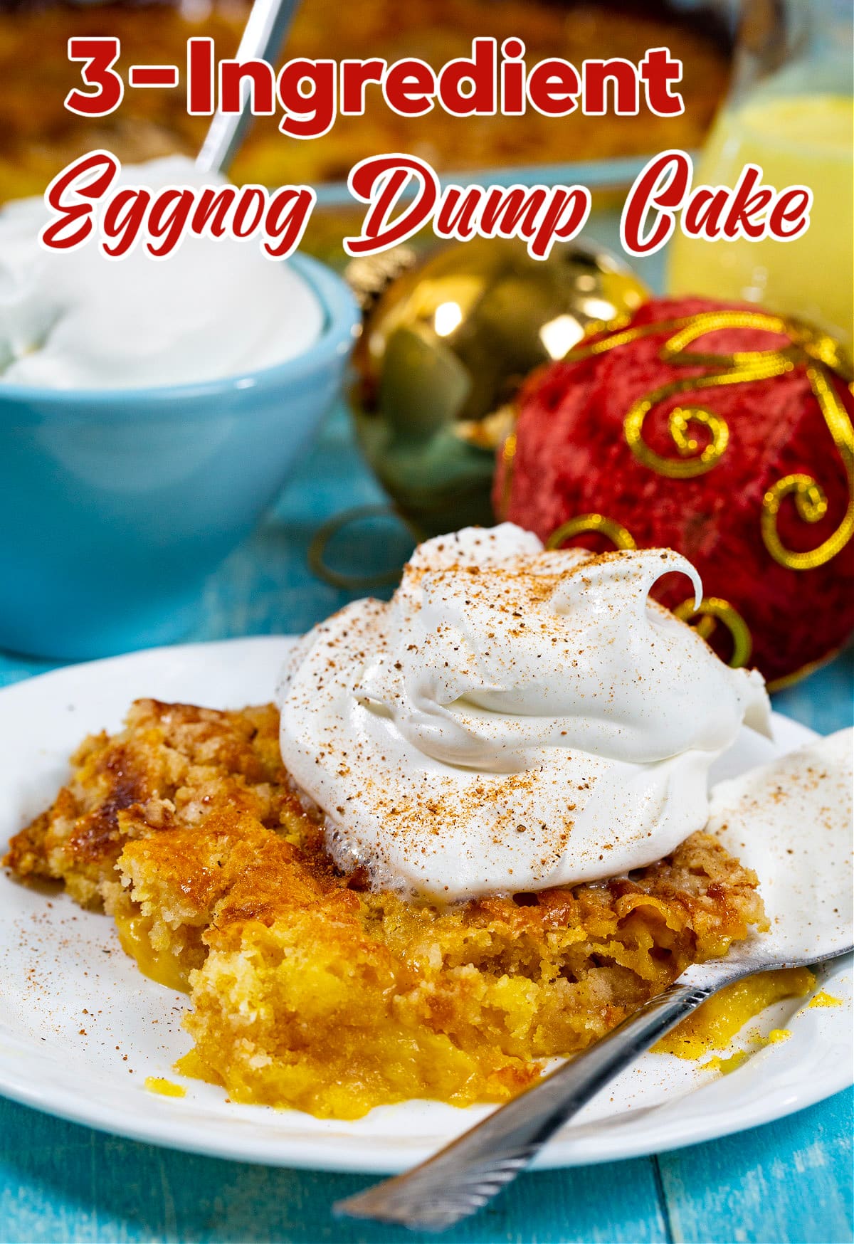 3-Ingredient Eggnog Dump Cake topped with whipped cream.