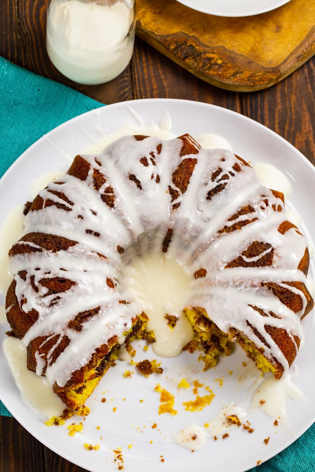 Honey Bun Bundt Cake with a few slices cut away on a serving plate.