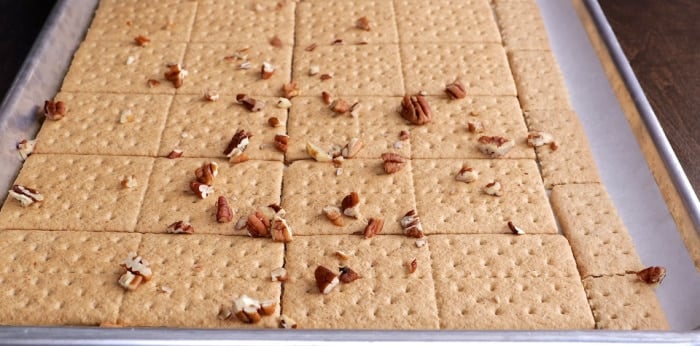 Sprinkling pecans on top.