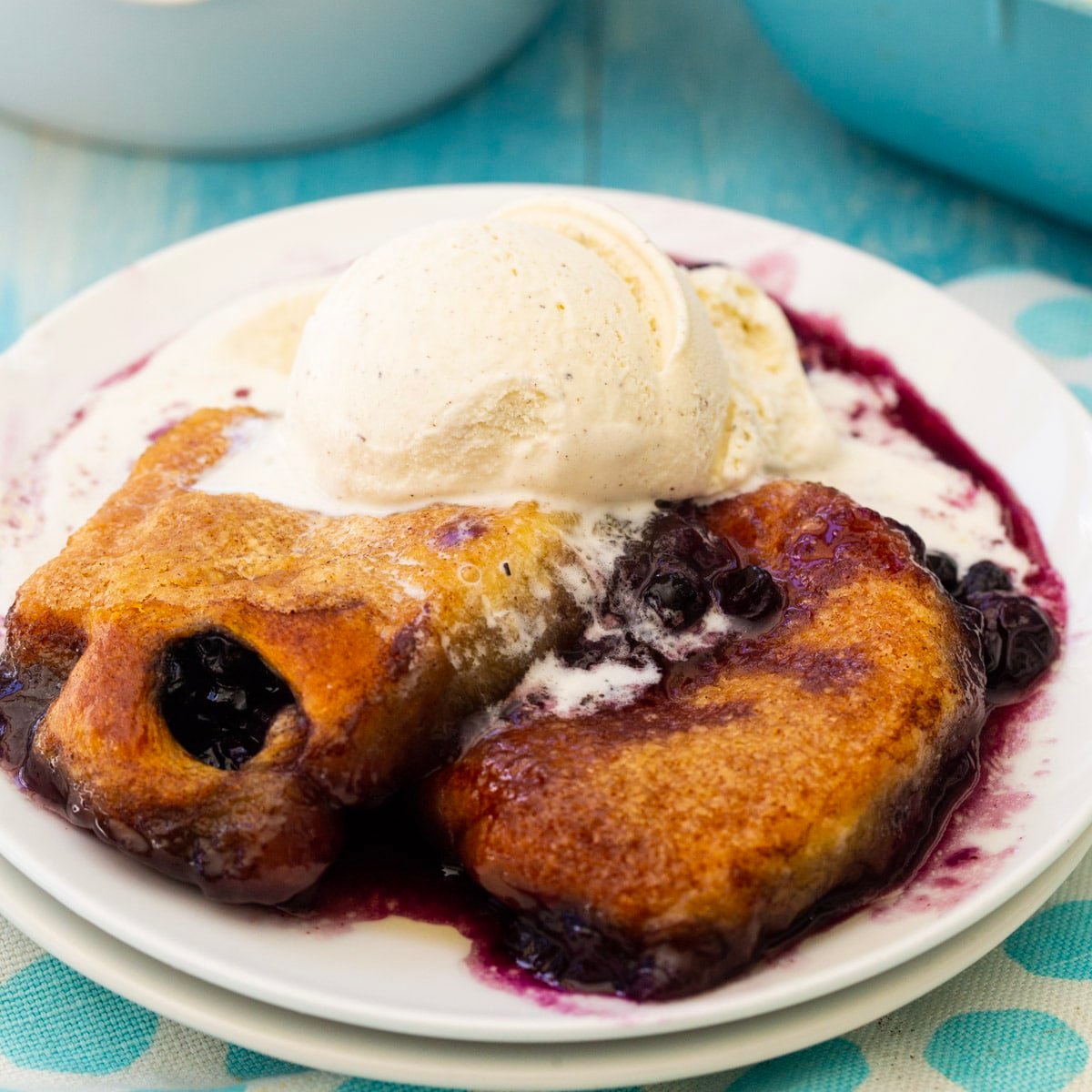 Blueberry Dumplings topped with ice cream.