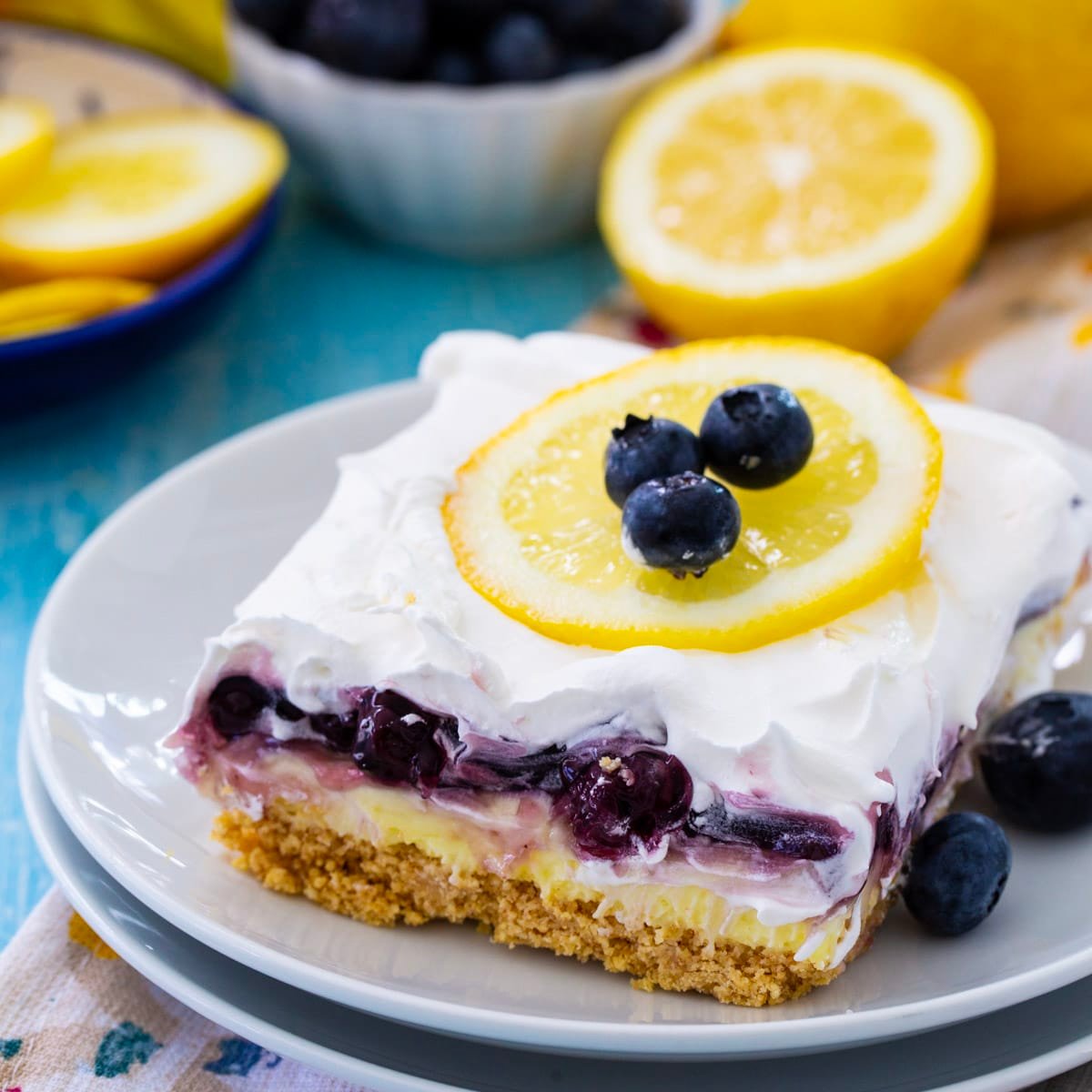 Slice of Blueberry Lemon Layer Dessert on a plate.