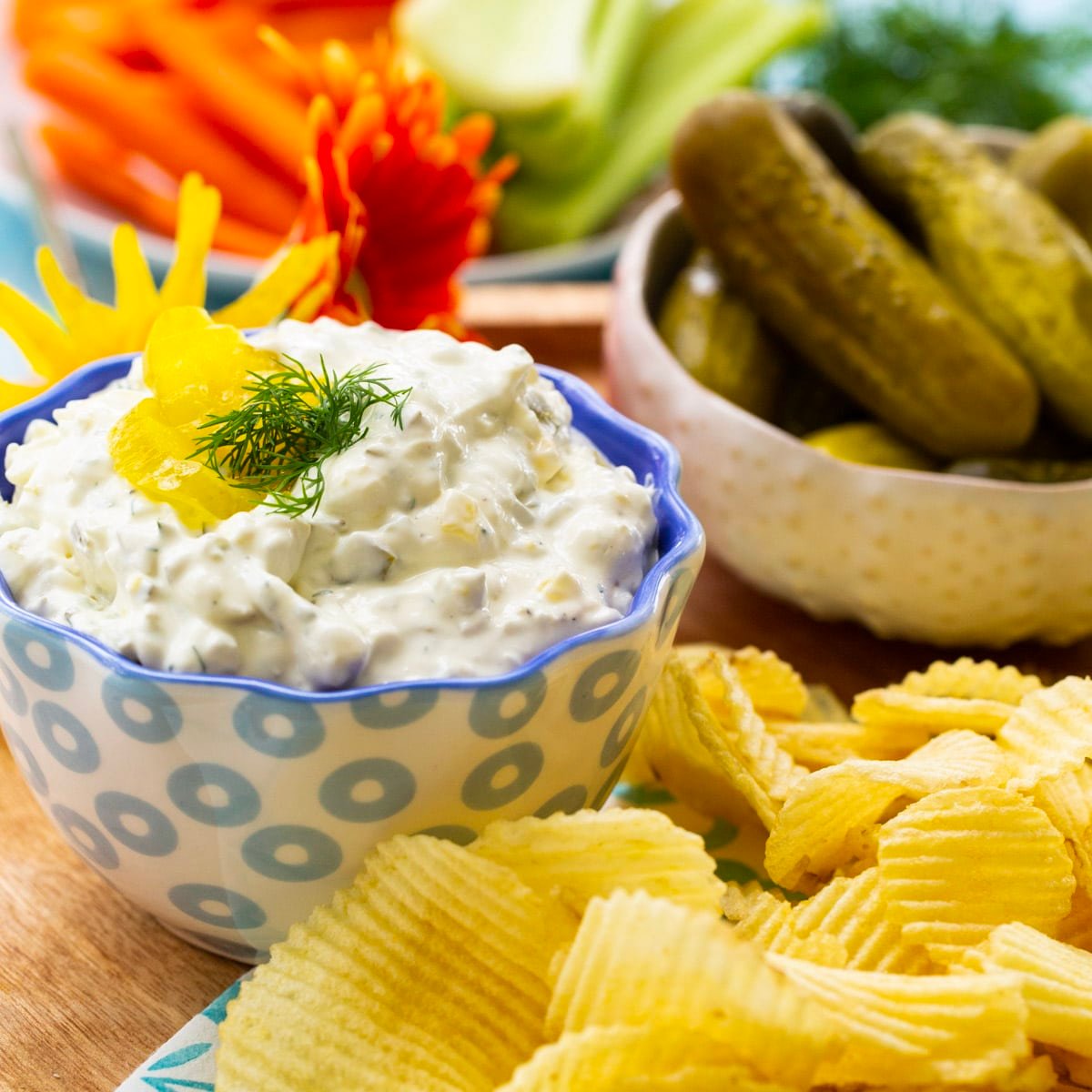 Dill Pickle Dip in a bowl surrounded by chips.