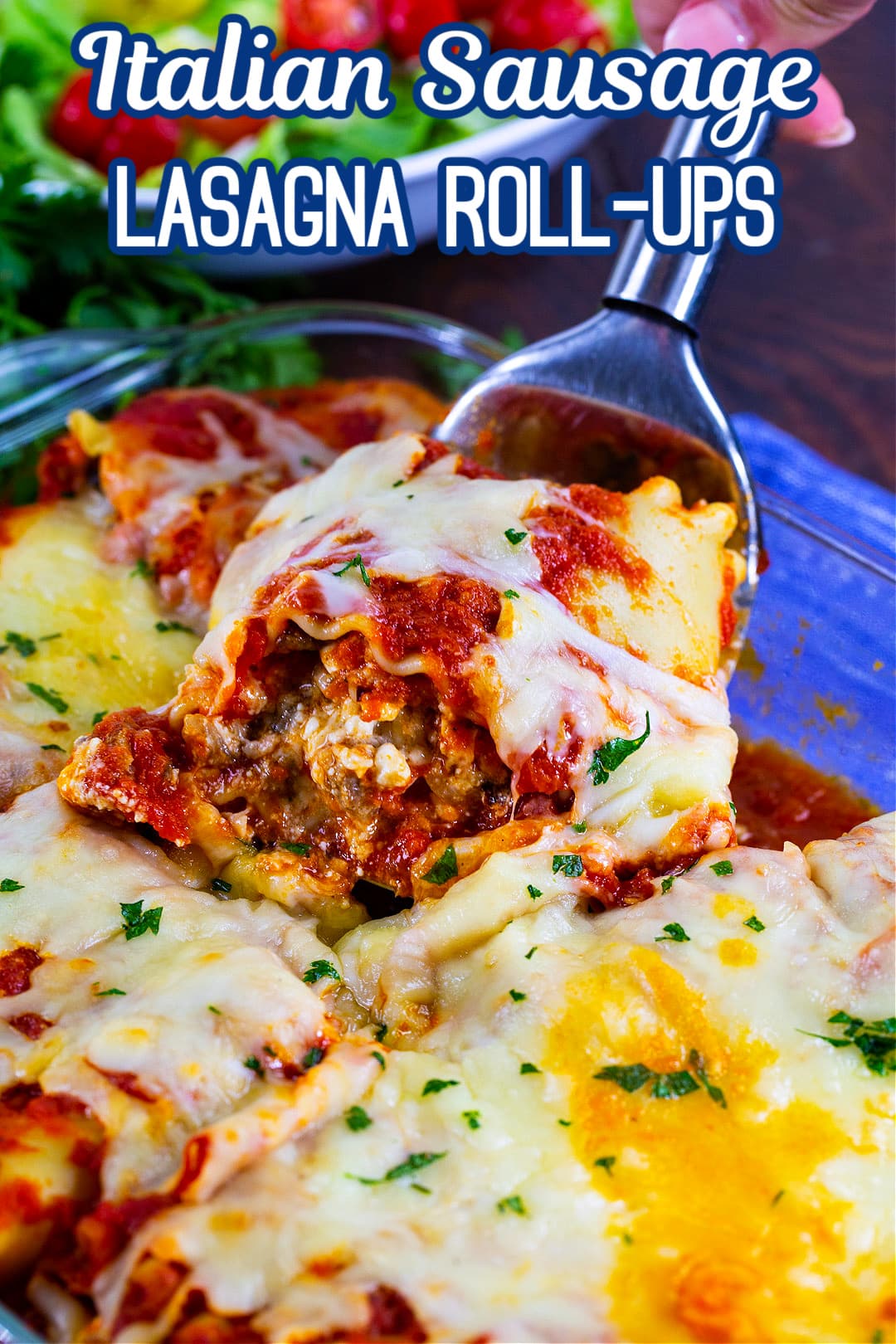 Italian Sausage Lasagna Roll-Up being lifted out of pan.