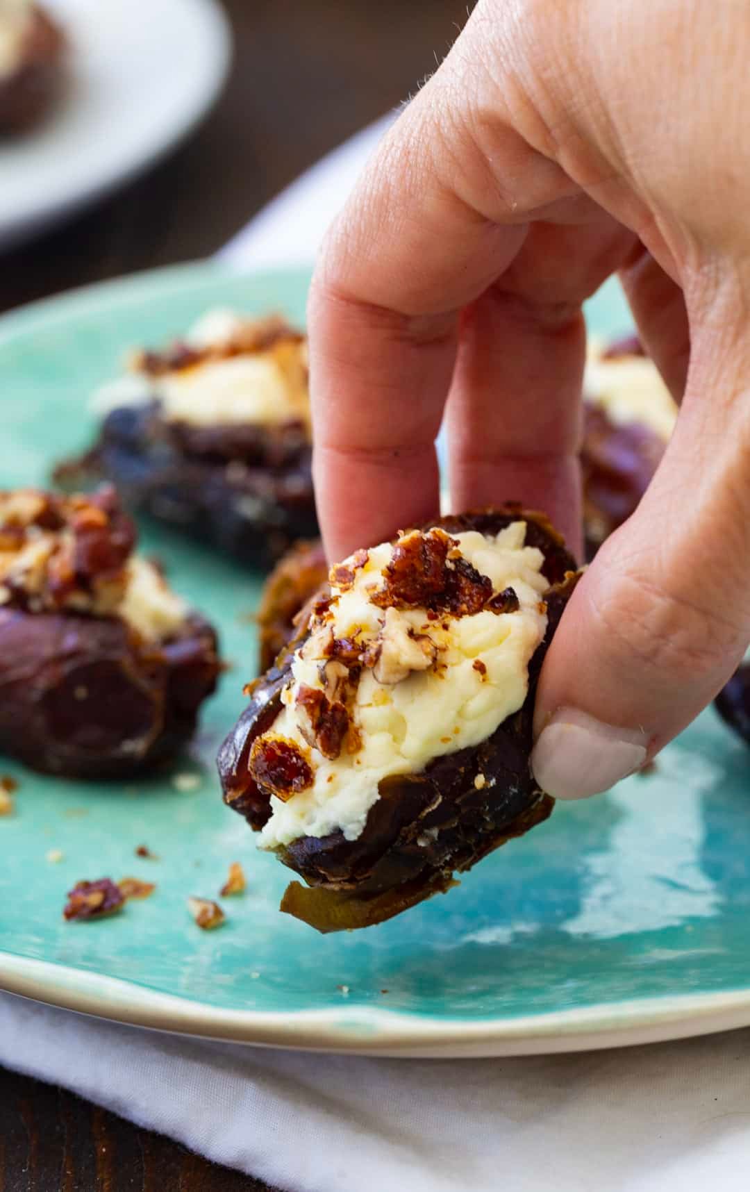 Hand picking up a stuffed date.