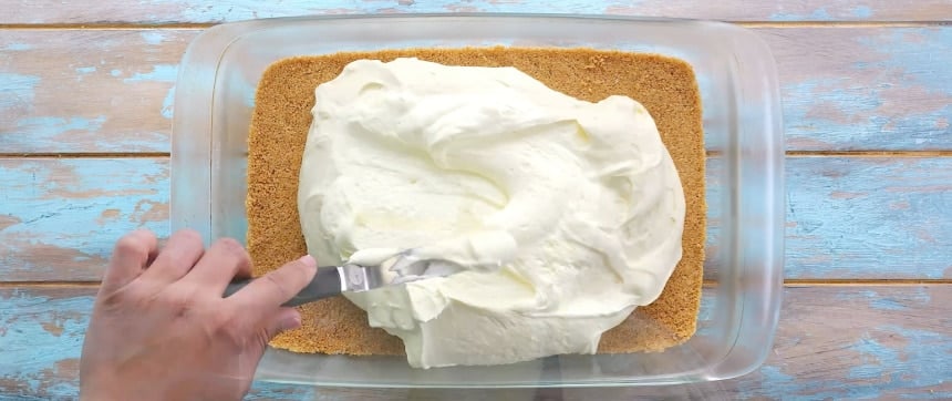 Spreading lemon layer on crust.