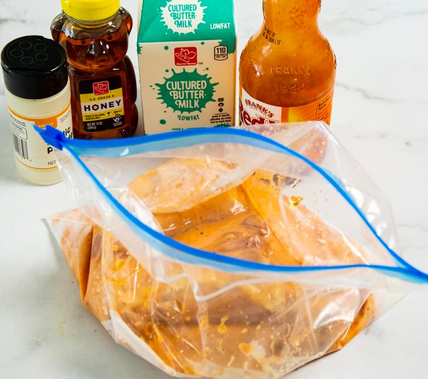 Ingredients and chicken in marinade.