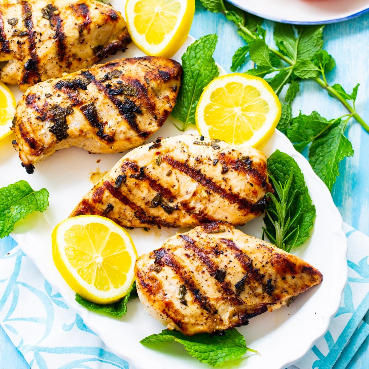 Grilled Chicken marinated in Greek Lemon Mint Marinade on a plate.