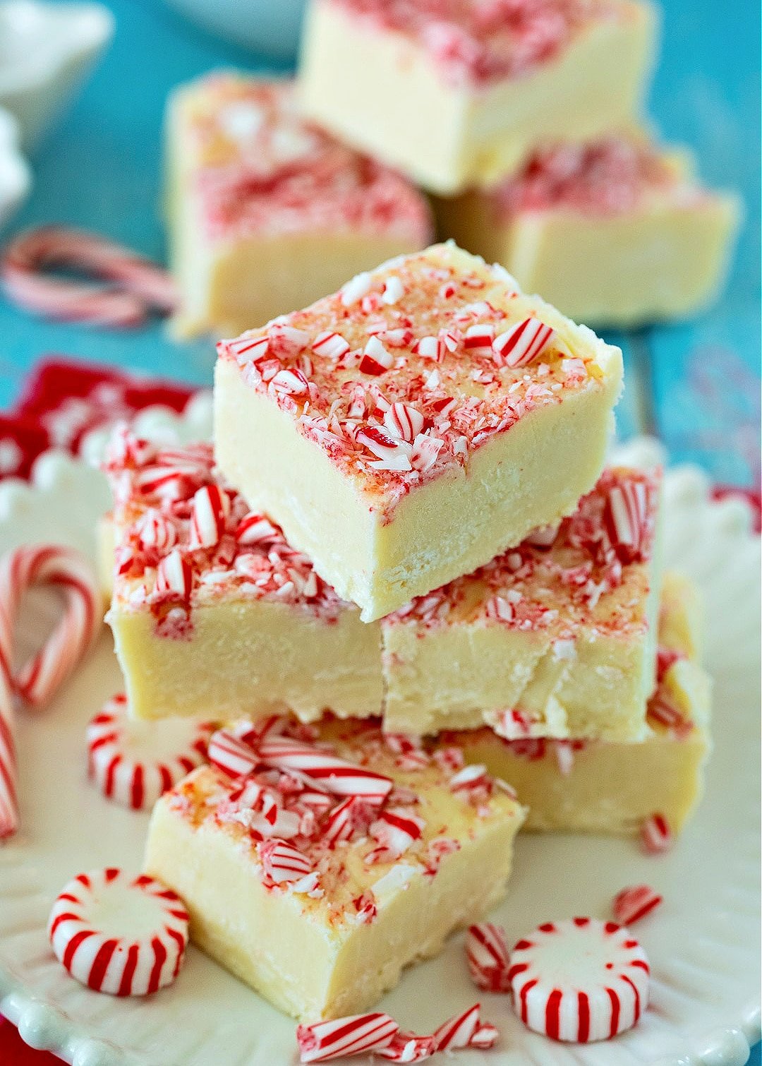Peppermint White Chocolate Fudge stacked up on a plate.