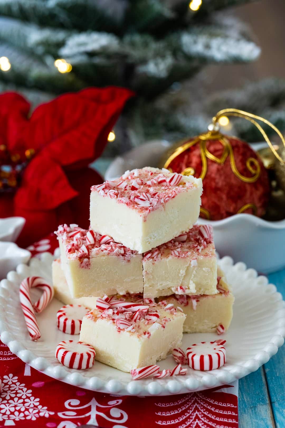 Fudge on a plate and Christmas decorations in background.