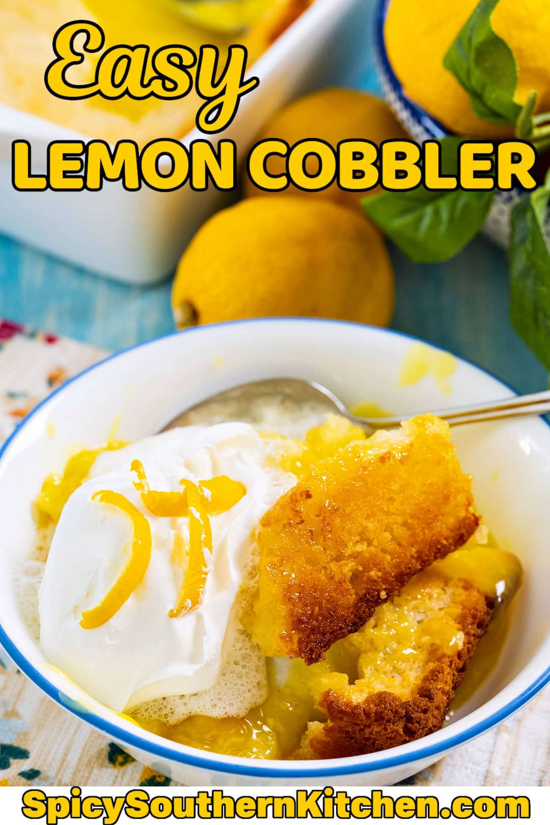 Lemon Cobbler topped with whipped cream in a bowl.