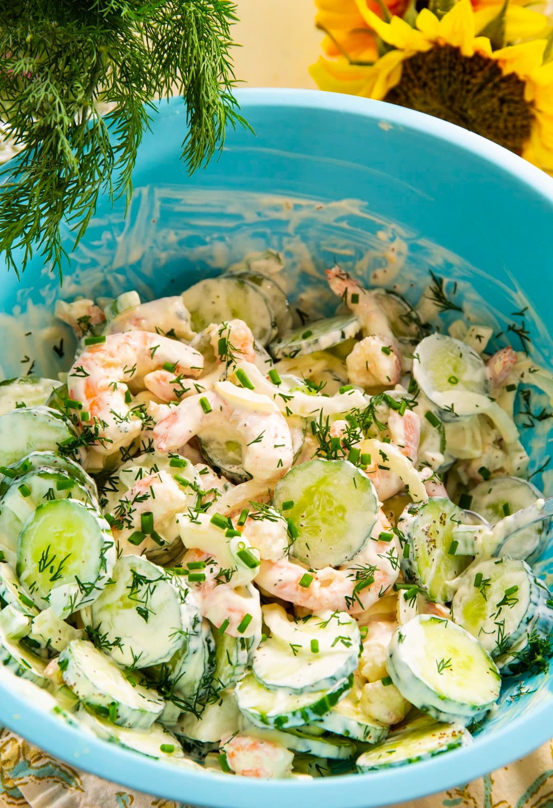 Shrimp salad in a large blue mixing bowl.