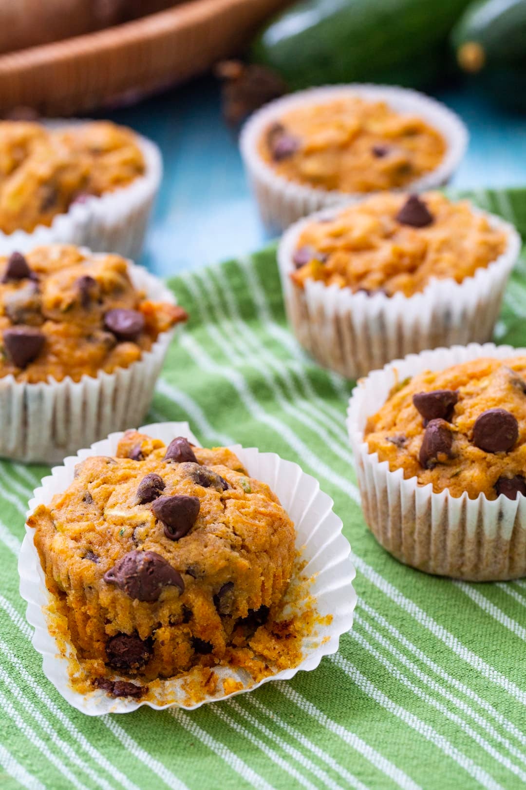 Sweet Potato Zucchini Muffins on a green and white tea towel.
